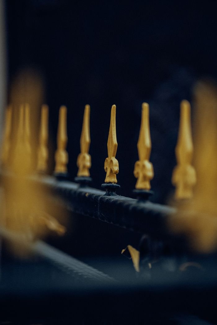 Elegant golden fence spikes in Fethiye, captured with selective focus.